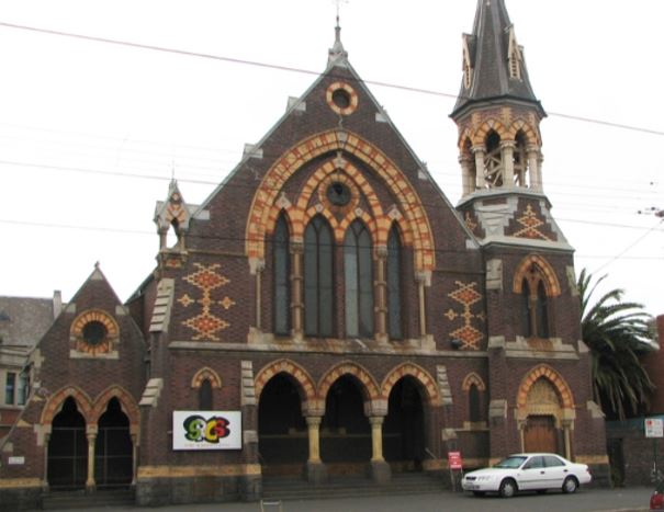 Shows the exterior of the church with a car parked out the front. 