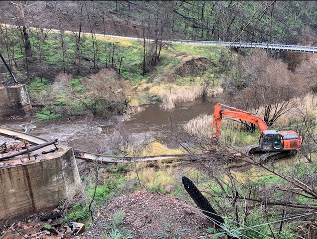 Work being done in the forest to clean up after a disaster  